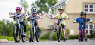 Four children on Coast Trail bikes.