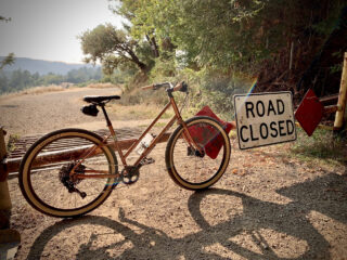Marin Larkspur 2 bike leaning up a road closed gate, Occidental CA