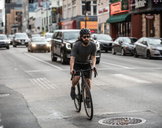 Man riding in city on drop bar bike