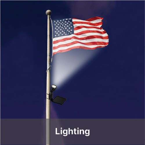 United States flag flying from flag pole with spotlight - Shop Lighting